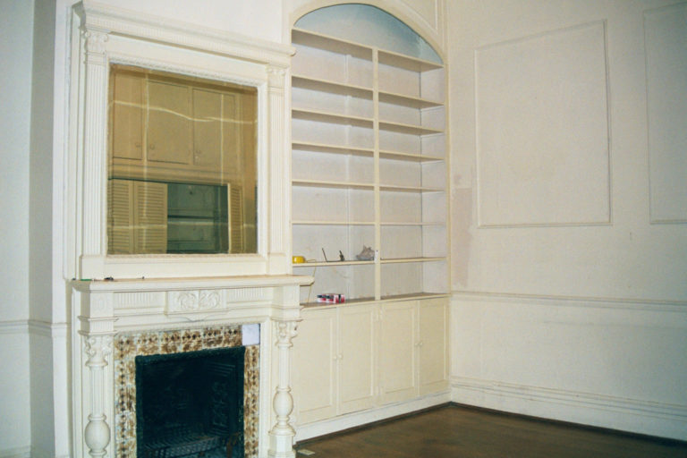 Rear Parlor mantel, mirror and built-in bookcase, closet reflected in the mirror