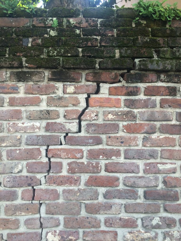 Improper repointing with Portland cement on an ancient wall in Savannah GA caused it to crack